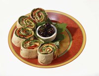 Tortilla roll-ups are pretty on a plate.