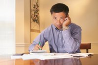 Man with bills and checkbook