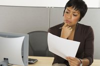 Fact checker looking at document in front of computer.