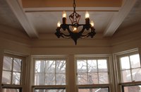 Chandeliers that appear small from ground level can actually be large, heavy fixtures.