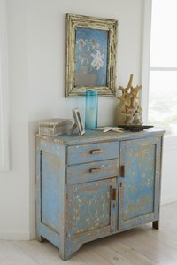 Combine a darker basecoat with a lighter topcoat to antique a dresser.