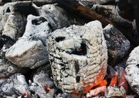 Hardwood coals provide slow, even heat for pit cooking.
