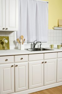 Leaky garbage disposals can create foul smells and cause water damage in kitchen cabinets.