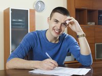 Man filling out form in kitchen
