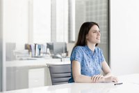 A business manager is sitting at a table.