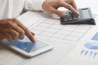 A businessman is working on a financial analysis.