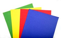 Use construction paper in primary colors to make spots for a cardboard Twister costume.