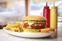 Cheeseburger and fries on diner table