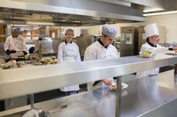 Food being prepared in a restaurant kitchen.