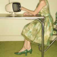 A woman sits at at a 1950s formica table with chrome trim.