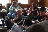 Residents participating in a group therapy session in a living room.