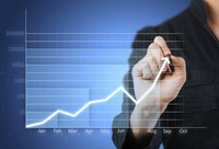 A man is tracking business earnings.