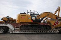 Construction vehicles arriving at a work site.