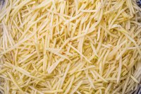 Shred clean potatoes with a food processor or a box grater before prepping for the freezer.