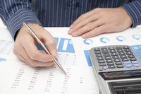 Man with spreadsheet and calculator