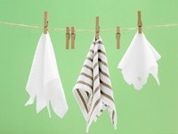 Just about any light cloth is suited to partially covering a cockatiel's cage.