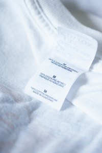 Cotton T-shirts shrink under high temperatures during both the washing and the drying cycles.