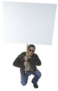 Make a sign on a stick to carry in a protest march.