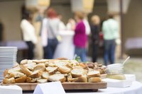 Close-up of catered lunch with business employees in background