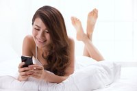 A young woman is looking at her cellphone.