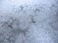Epsom salts crystallizing on a window resemble ice crystals.