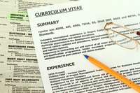 Glasses and a pencil on top of two resumes.