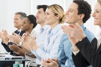 A group of coworkers give a round of applause in response to a product endorsement presentation
