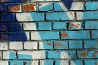 Remove spray paint off brick walls with solvents.