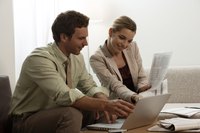 Business partners are working on their computers together.