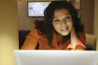 A businesswoman is using her laptop.