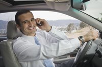 A man is on his cell phone driving to work.
