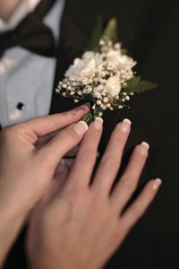 Pin a boutonniere to a shirt as you would a lapel.