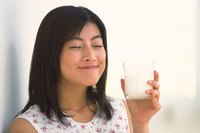 Young woman holding glass of milk.