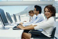 Side view of a row of office workers typing on their computers