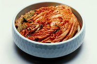 Kimchi is fermented, seasoned cabbage, a staple of Korean cuisine.