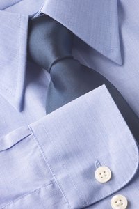 Leave the stays in your shirt but remove any pins before wearing it.