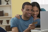 A couple using a card to shop online.