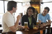 Three guys are drinking beer together.
