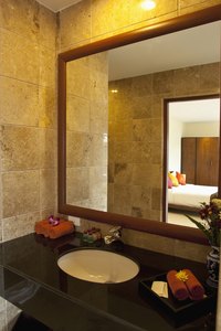 Many commercial bathrooms contain multiple stalls and a shared sink.
