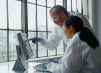 Scientists looking at a computer screen.