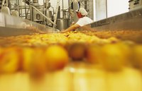 A woman inspecting product on the conveyor belt.