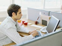 Man working in an office cubicle.