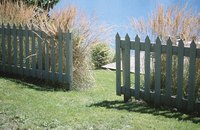 The railing on a vinyl fence supports the vertical pickets.
