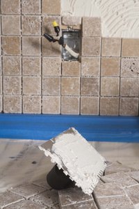 Use grout between tiles and silicone at the edges of the shower.