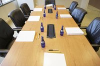A high angle view of informational binders on a conference room table.