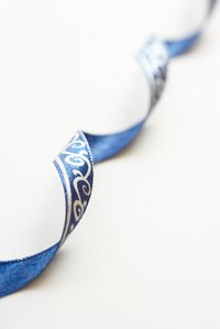 Loosely curl fabric ribbon to top a special gift.