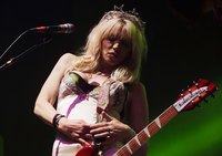 Courtney Love sports a vintage-style dress and a starry tiara for a concert in Sydney in August 2014.