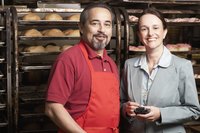 A small business owner is standing next to a woman in business clothes.