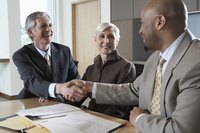 Three business executives in a meeting together.
