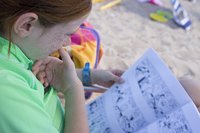 A young kid is reading a comic book.
